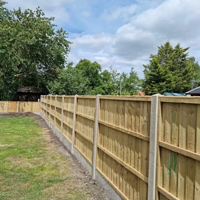 Closeboard timber fencing installed with concrete posts along a garden boundary